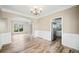 Open dining area with wood-look floors, wainscoting detail, and easy access to the kitchen at 217 Park Creek Dr, Woodstock, GA 30188