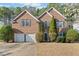 Charming two-story brick home with well-manicured landscaping and an inviting double garage at 217 Park Creek Dr, Woodstock, GA 30188