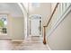 Welcoming foyer with beautiful wood-look tile flooring and a staircase with white railings at 217 Park Creek Dr, Woodstock, GA 30188