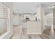 Bright kitchen features white cabinetry, stainless appliances, and wood-look floors at 217 Park Creek Dr, Woodstock, GA 30188