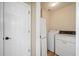 A compact laundry room equipped with a washer, dryer, and extra storage, maximizing functionality at 217 Park Creek Dr, Woodstock, GA 30188
