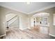 Open-concept living room featuring wood-look floors, crown molding, and arched doorways at 217 Park Creek Dr, Woodstock, GA 30188