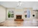 Cozy living room featuring brick fireplace and many windows bringing in natural light at 217 Park Creek Dr, Woodstock, GA 30188