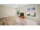 Living room showcasing the brick fireplace, many windows, and beautiful wood-look flooring at 217 Park Creek Dr, Woodstock, GA 30188