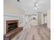 Open-concept living room with fireplace and wood-look flooring throughout at 217 Park Creek Dr, Woodstock, GA 30188