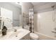 Well-lit bathroom featuring a tub shower, modern sink, mirror, storage shelves, and a neutral color scheme at 4020 F A A Rd, Cumming, GA 30041