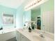 Bright bathroom featuring a double sink vanity, soaking tub, and large window for natural light at 4020 F A A Rd, Cumming, GA 30041