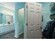 Bathroom featuring double vanity, toilet and linen closet, and doorway to bedroom with closet at 4020 F A A Rd, Cumming, GA 30041