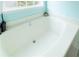 A deep soaking tub with jets is positioned near a window for natural light at 4020 F A A Rd, Cumming, GA 30041