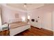 Bedroom features a large bed, hardwood floors, and a view to an adjacent hall at 4020 F A A Rd, Cumming, GA 30041