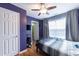 Cozy bedroom featuring a ceiling fan, light wood floors, and a bright window at 4020 F A A Rd, Cumming, GA 30041