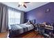 Bedroom with hardwood floors, a ceiling fan, and large window for natural light at 4020 F A A Rd, Cumming, GA 30041