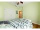 Bright bedroom showcasing hardwood floors, closet with double doors, and a view into another room at 4020 F A A Rd, Cumming, GA 30041