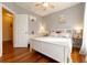 Bright bedroom featuring hardwood floors, a ceiling fan, and abundant natural light streaming through large windows at 4020 F A A Rd, Cumming, GA 30041