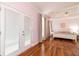 Bright bedroom with tray ceiling, hardwood floors, and French door access to deck at 4020 F A A Rd, Cumming, GA 30041