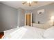 Inviting bedroom featuring hardwood floors, a ceiling fan, and a brightly lit doorway at 4020 F A A Rd, Cumming, GA 30041