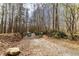 Entrance to Camp Lanier, featuring a gravel path and signage surrounded by dense trees at 4020 F A A Rd, Cumming, GA 30041