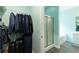 Walk-in closet with hanging storage and shelving, adjacent to bathroom with shower at 4020 F A A Rd, Cumming, GA 30041