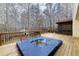 Back deck with hot tub and wooded view, perfect for relaxing outdoors at 4020 F A A Rd, Cumming, GA 30041
