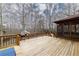 Spacious wooden deck with railing, screened porch access, and grill for outdoor entertaining at 4020 F A A Rd, Cumming, GA 30041