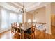 Dining room features a large window for natural light, chandelier, and table set for dinner at 4020 F A A Rd, Cumming, GA 30041