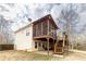 Exterior back view featuring a screened in porch, wooden deck and steps at 4020 F A A Rd, Cumming, GA 30041