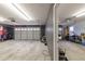 Bright garage featuring two white garage doors and smooth concrete flooring at 4020 F A A Rd, Cumming, GA 30041