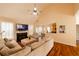 Cozy living room with a fireplace, TV, vaulted ceiling, and comfortable seating arrangement at 4020 F A A Rd, Cumming, GA 30041