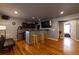 Finished room with hardwood floors, wet bar, television and recessed lighting at 4020 F A A Rd, Cumming, GA 30041
