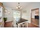 Cozy dining room with a dark wood table, white chairs, chandelier, and trim at 419 Saint Patrick Sw Dr, Mableton, GA 30126