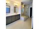 Modern bathroom featuring a glass shower, double vanity, and neutral color palette at 4191 Wisconsin Dr, Dunwoody, GA 30338