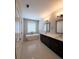 Bright bathroom boasting a freestanding tub, double vanity with dark cabinets, and tile floors at 4191 Wisconsin Dr, Dunwoody, GA 30338