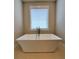 Contemporary freestanding bathtub placed beneath a window, offering a serene bathing experience at 4191 Wisconsin Dr, Dunwoody, GA 30338