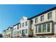 Row of bright townhouses with manicured lawns, garages, and lots of windows at 4191 Wisconsin Dr, Dunwoody, GA 30338