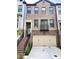 Beautiful brick townhouse with an attached two-car garage and manicured landscaping at 4191 Wisconsin Dr, Dunwoody, GA 30338