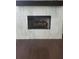 Elegant fireplace with a dark wood mantel and light stone surround complementing the dark wood flooring at 4191 Wisconsin Dr, Dunwoody, GA 30338