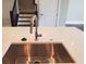 Close-up of the kitchen sink and countertops, complemented by views of the staircase at 4191 Wisconsin Dr, Dunwoody, GA 30338