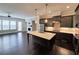 Open-concept living area with a kitchen island, fireplace and dark hardwood floors at 4191 Wisconsin Dr, Dunwoody, GA 30338