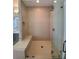 Elegant glass enclosed shower with a built-in bench and modern fixtures at 4191 Wisconsin Dr, Dunwoody, GA 30338