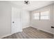 Bright bedroom features light-colored walls, hardwood floors, and a large window that provides natural light at 4611 Old Westside Rd, Austell, GA 30106