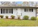 Inviting single-Gathering home with dark shutters, a bright white door, and a landscaped yard at 4611 Old Westside Rd, Austell, GA 30106