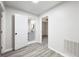Hallway featuring modern gray flooring leading to a stylish bathroom at 4611 Old Westside Rd, Austell, GA 30106