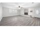 Spacious living area featuring painted brick fireplace, and updated flooring at 4611 Old Westside Rd, Austell, GA 30106