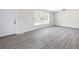 Bright living room boasts new gray laminate floors and a fresh coat of white paint at 4611 Old Westside Rd, Austell, GA 30106