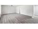 Inviting living room features modern gray flooring and freshly painted white walls at 4611 Old Westside Rd, Austell, GA 30106