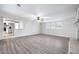 Open-concept living room showcases painted brick, lots of light, and kitchen access at 4611 Old Westside Rd, Austell, GA 30106
