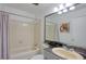 Bathroom featuring a shower-tub combo with curtain, toilet, sink, marble countertop and vanity at 4938 Terrace Green Trce, Stone Mountain, GA 30088