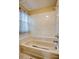Tiled bathtub and shower with a window and shower curtain for added privacy in bathroom at 4938 Terrace Green Trce, Stone Mountain, GA 30088
