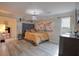 Spacious bedroom with hardwood floors, a comfortable bed, and ample natural light at 4938 Terrace Green Trce, Stone Mountain, GA 30088