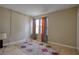 Cozy bedroom with wood laminate flooring and large window dressed with two-toned curtains at 4938 Terrace Green Trce, Stone Mountain, GA 30088